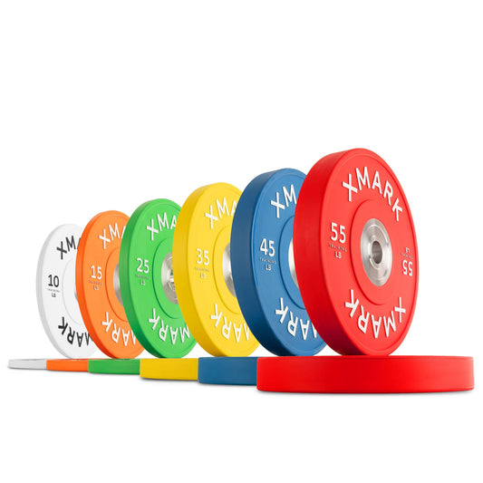 Colorful commercial bumper plates in various weights, featuring raised lettering and a glossy matte finish for effective lifting.