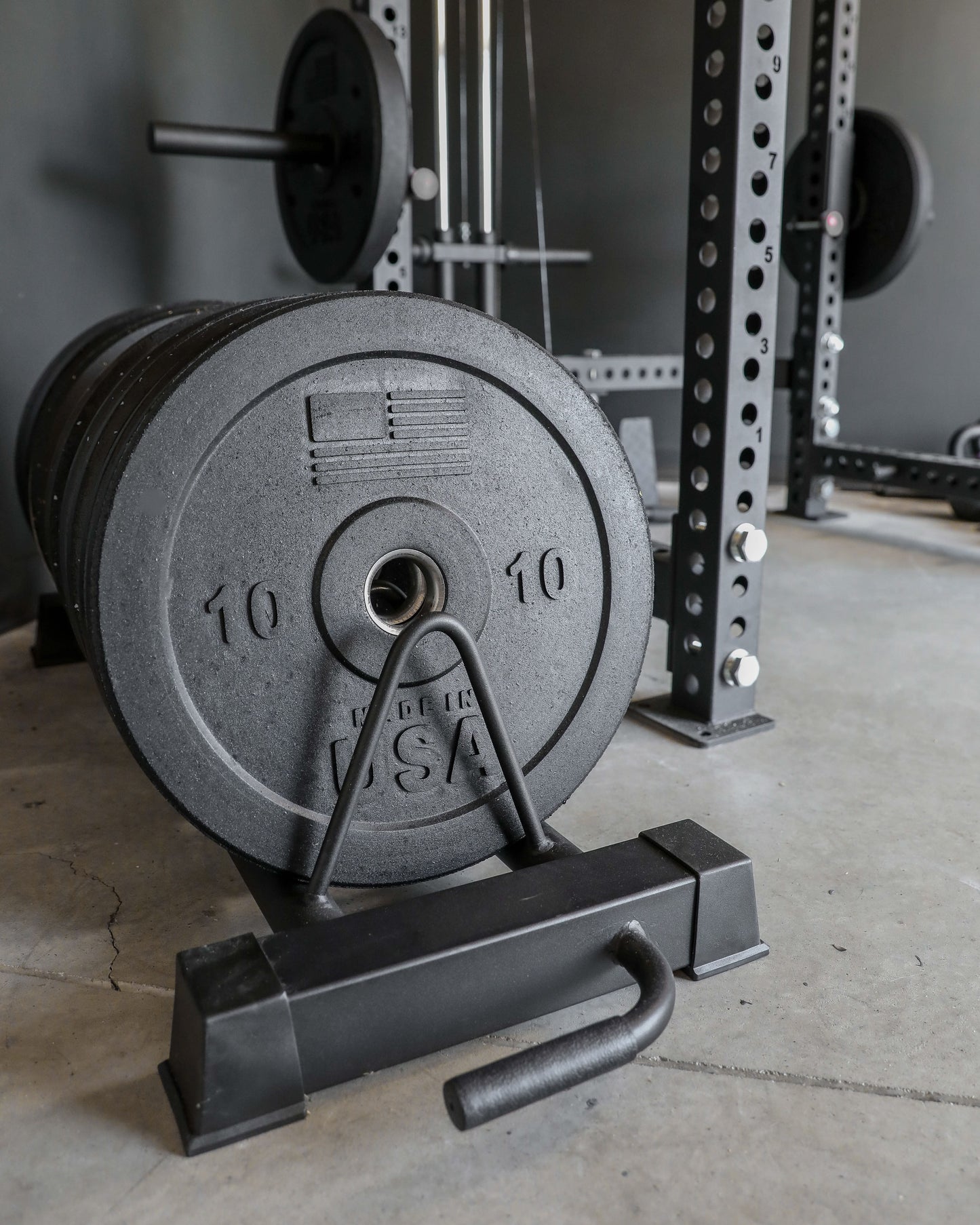 USA Bumper Plate Set - profile view with plates stored on a rack