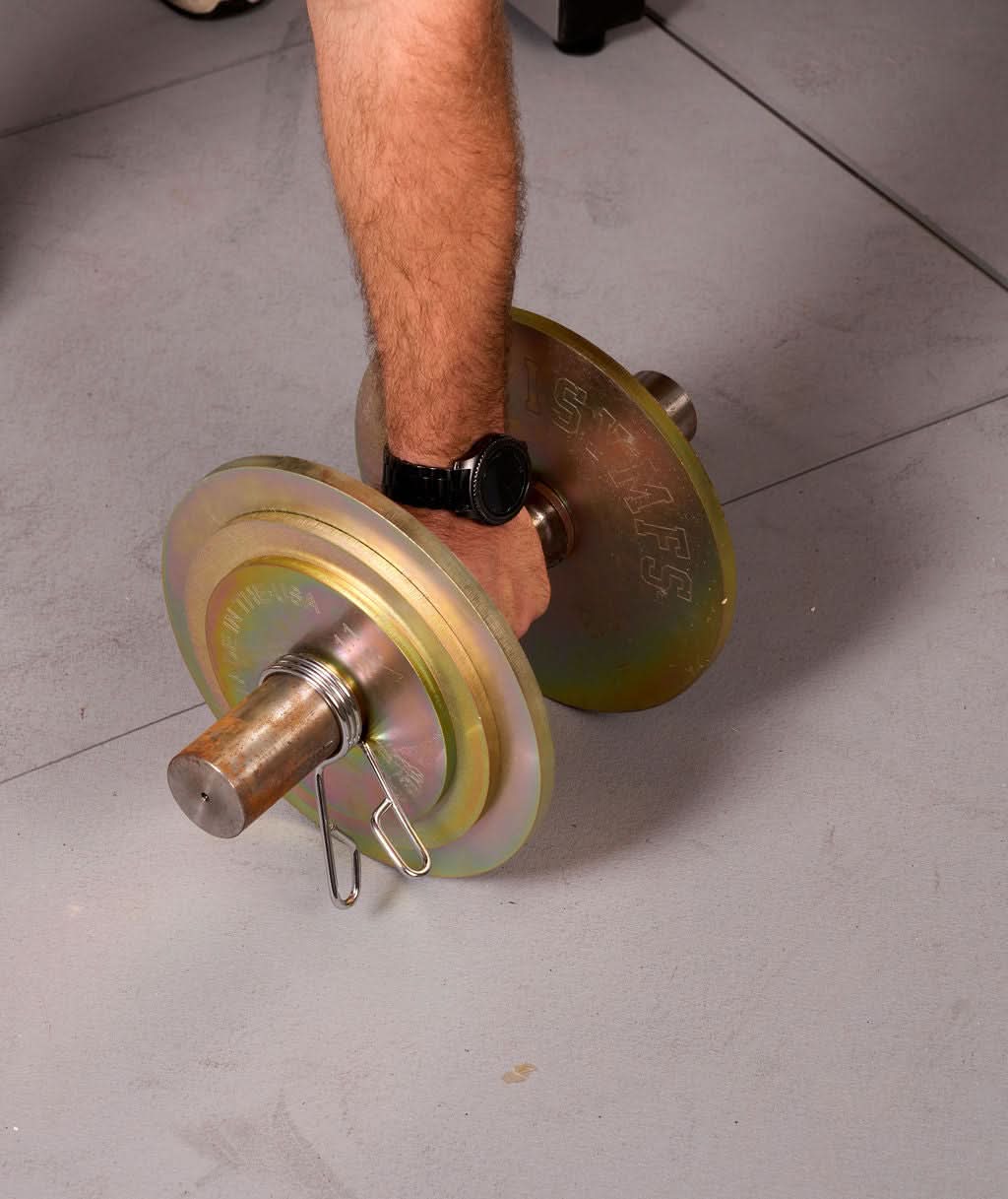 Solid Steel Loadable Dumbbell Sets - perspective view of a person gripping the loaded dumbbell (gold)