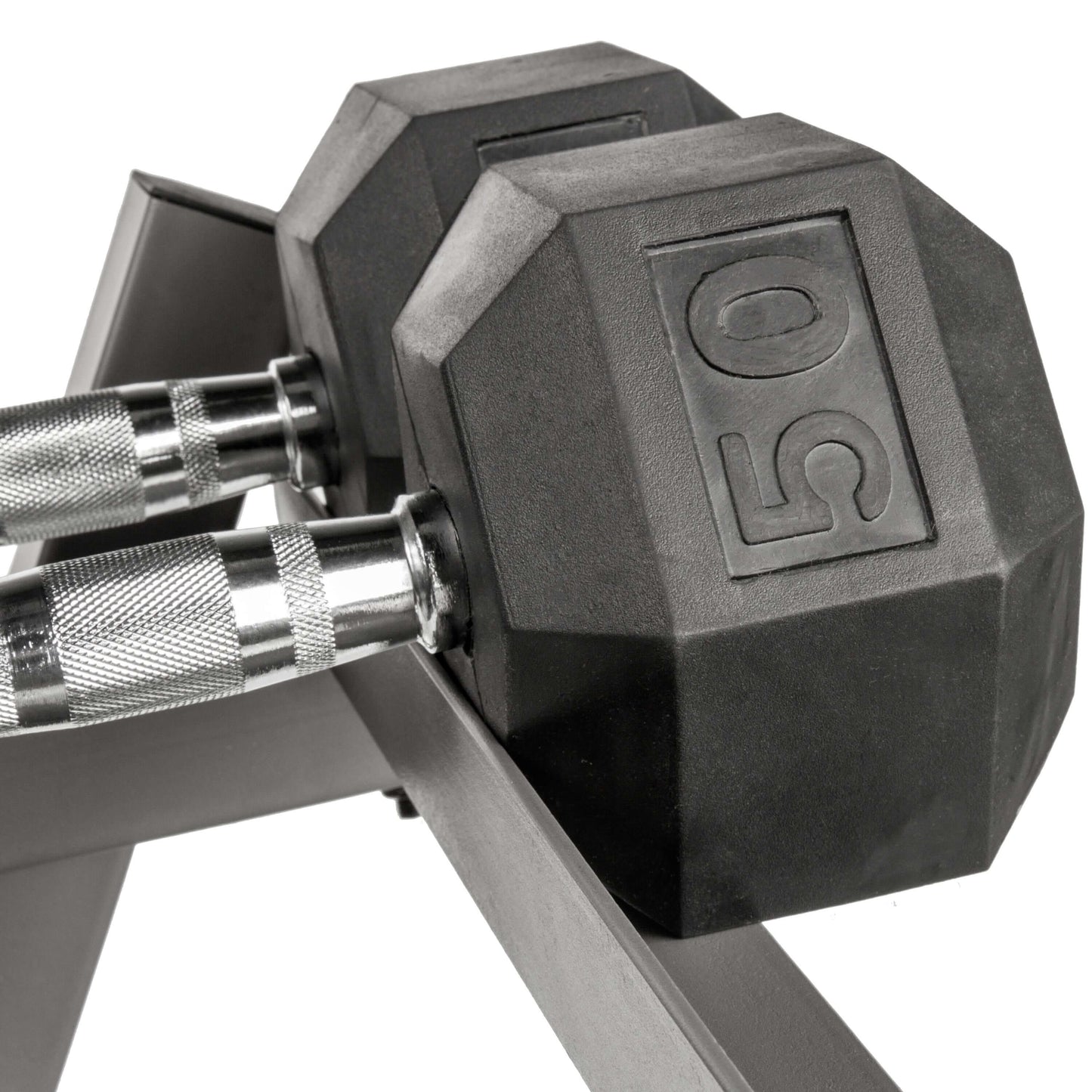Close-up of a 50 lb hex dumbbell on a storage rack, showcasing its durable rubber design for home gym setups.