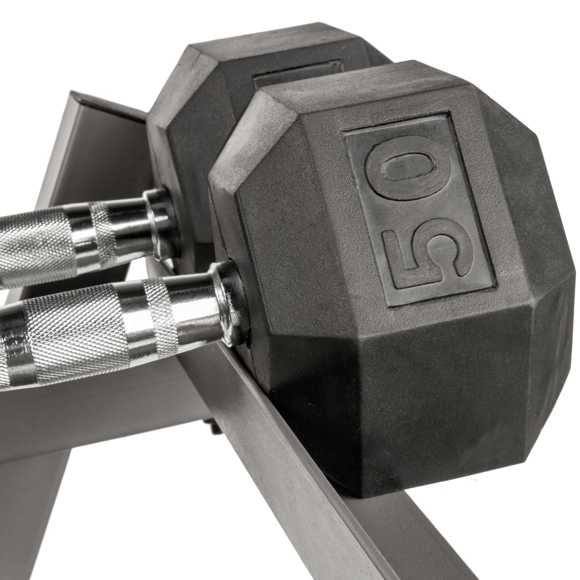 Close-up of a 50 lb hex dumbbell on a storage rack, showcasing its durable rubber design for home gym setups.