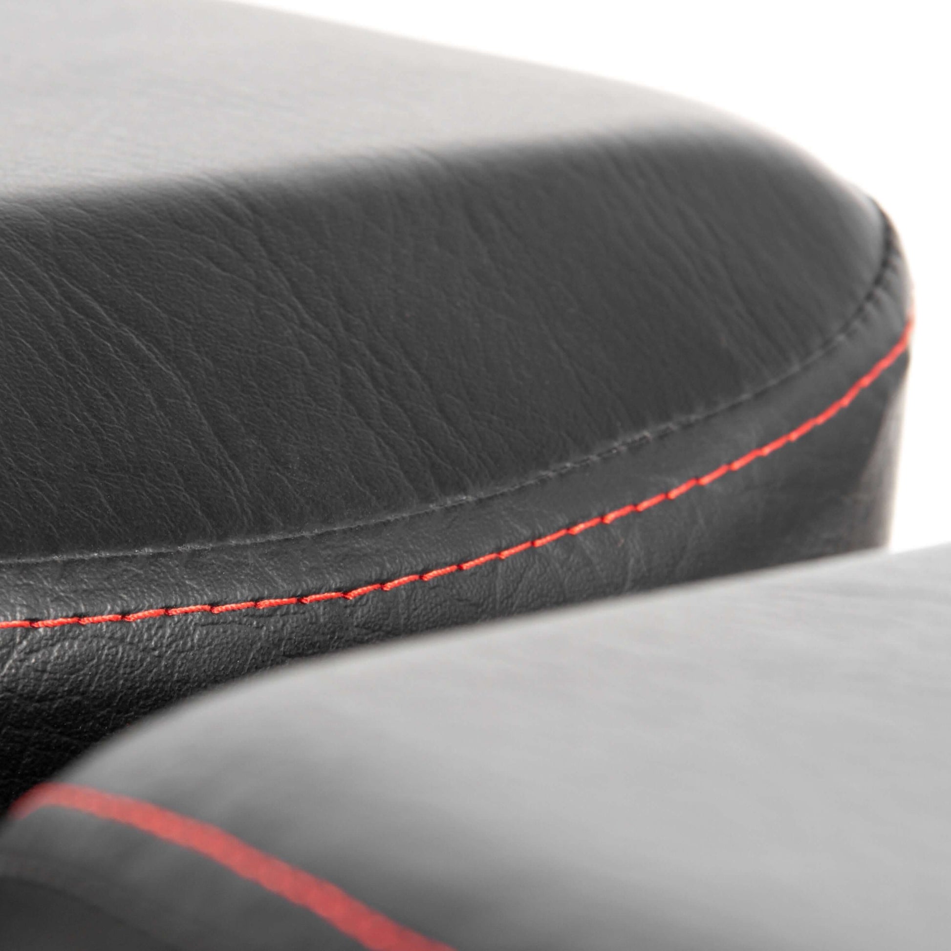 Close-up of the power series adjustable dumbbell weight bench padding with black leather and red stitching detail.