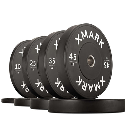 Set of durable commercial black bumper plates ranging from 10 to 45 pounds, featuring a gloss matte finish and XMARK branding.