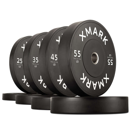 Commercial black bumper plates in various weights (25, 45, 55 lbs) designed for durability and impact absorption.