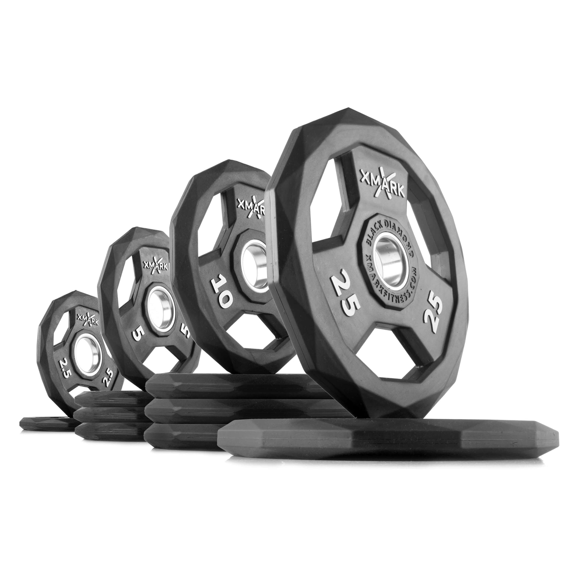 Black Diamond Olympic weight plates stacked and arranged, showcasing durable, rubber-encased design for gym use.