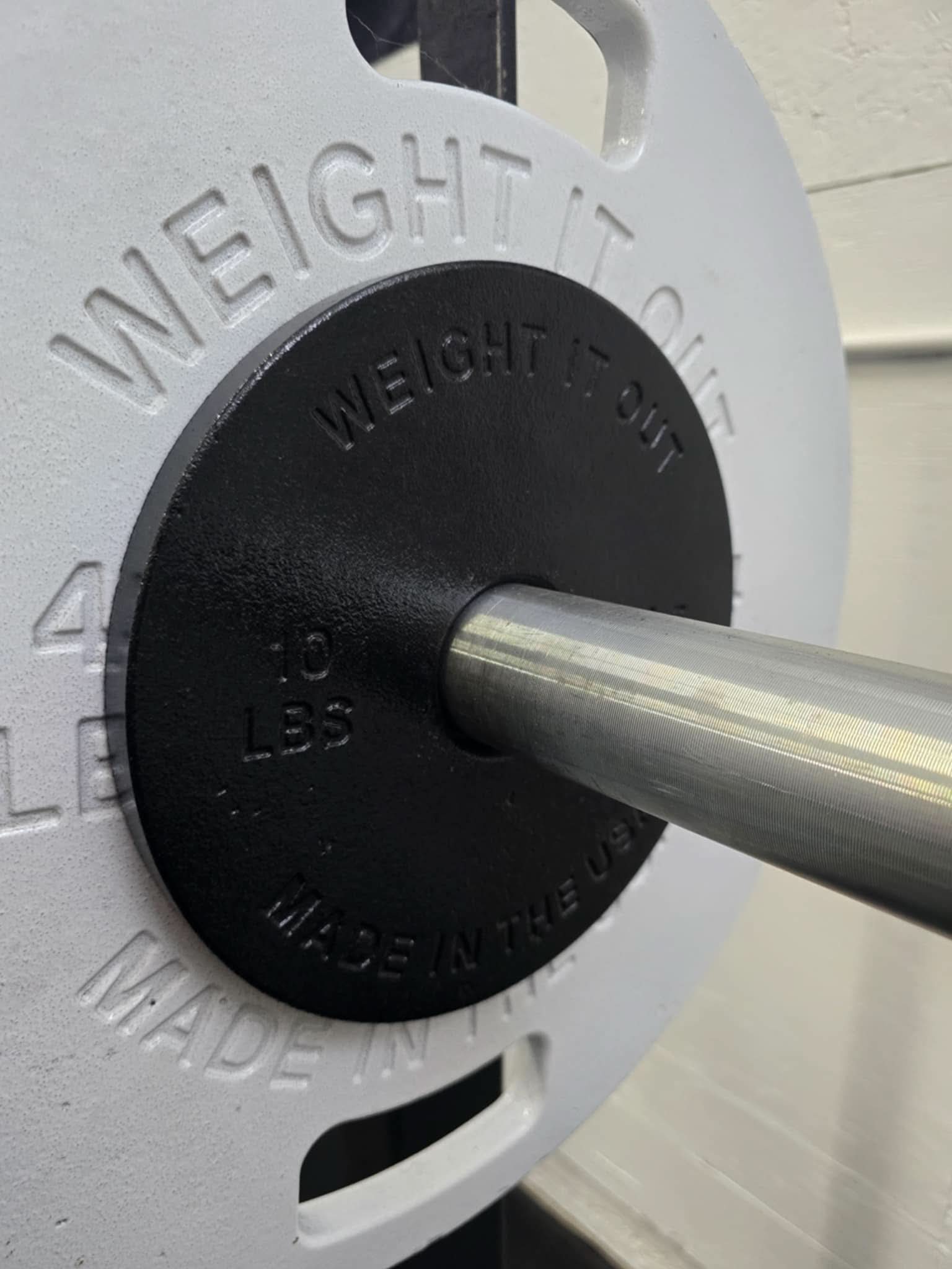 Cast Iron Machined Weight Plate Sets - close up view of plates loaded on barbell 