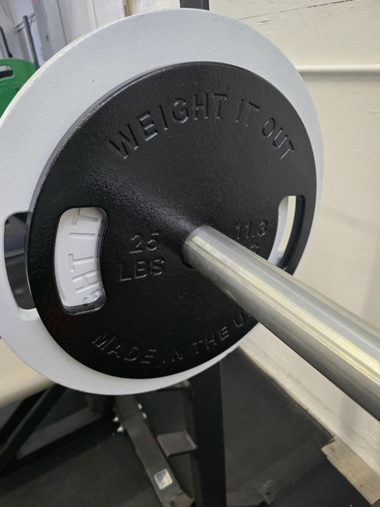 Cast Iron Machined Weight Plate Sets - perspective view of plates loaded on barbell
