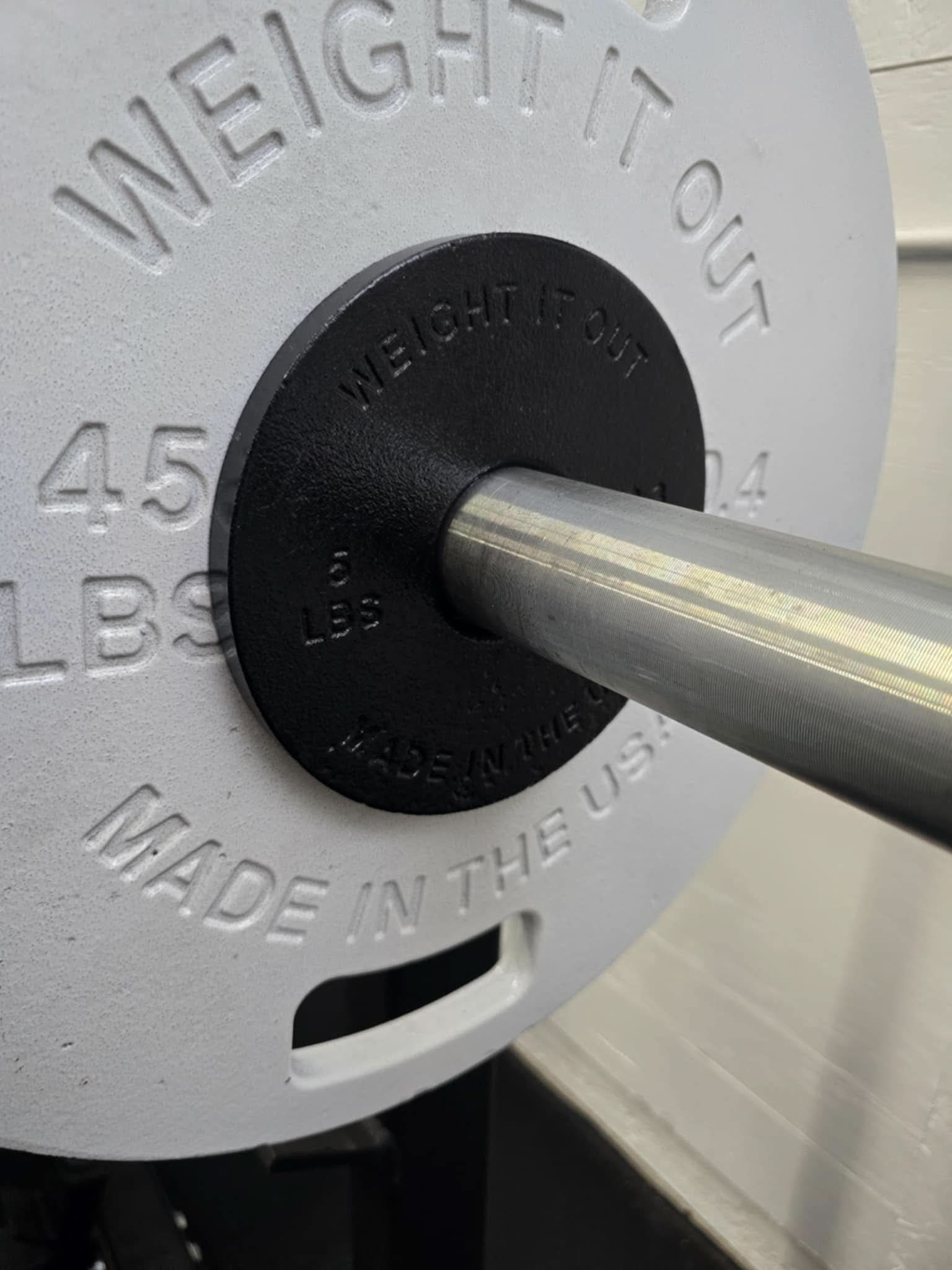 Cast Iron Machined Weight Plate Sets - perspective view of plates on barbell sleeve