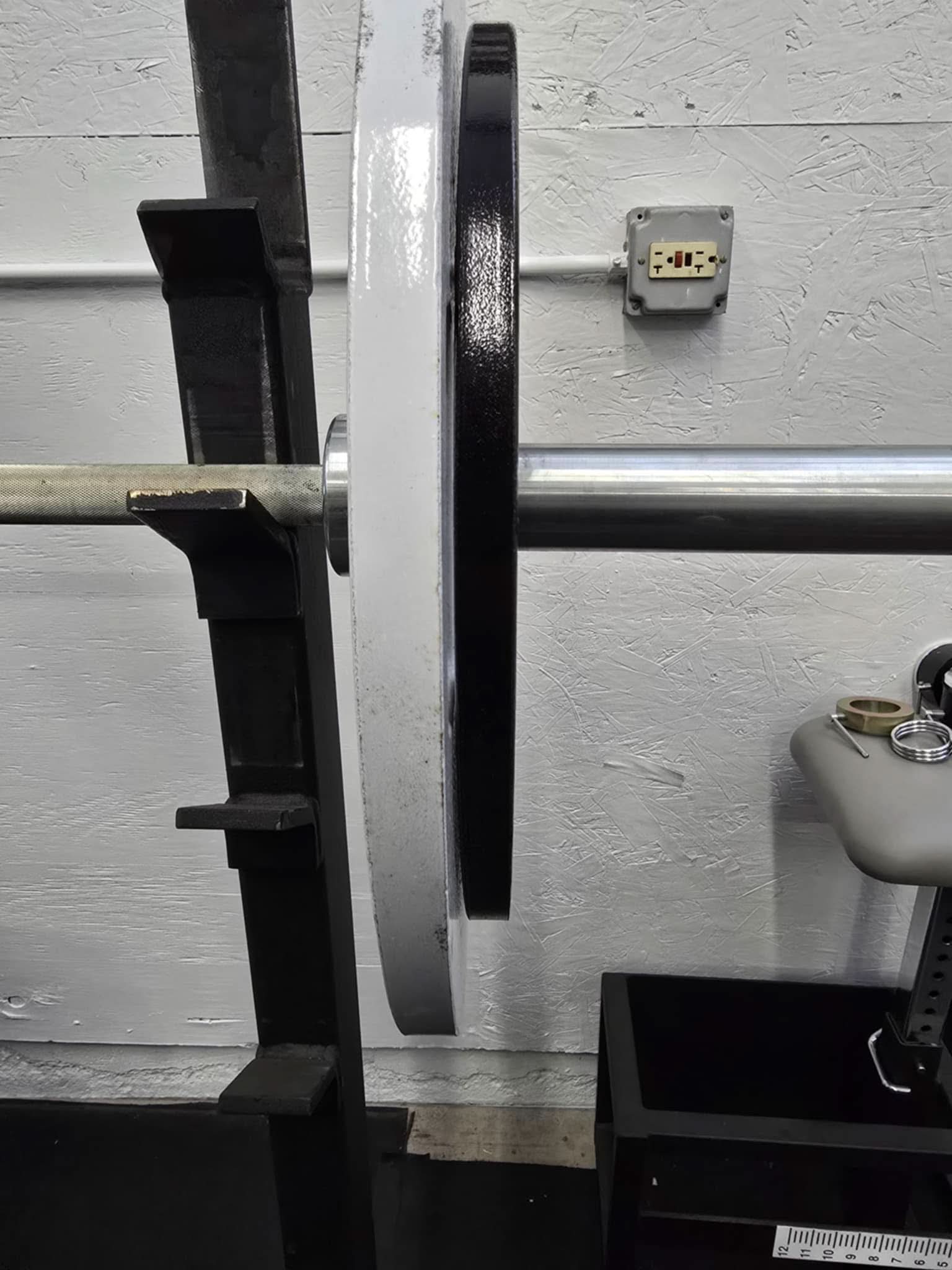 Cast Iron Machined Weight Plate Sets - side view of plates loaded on barbell sleeve