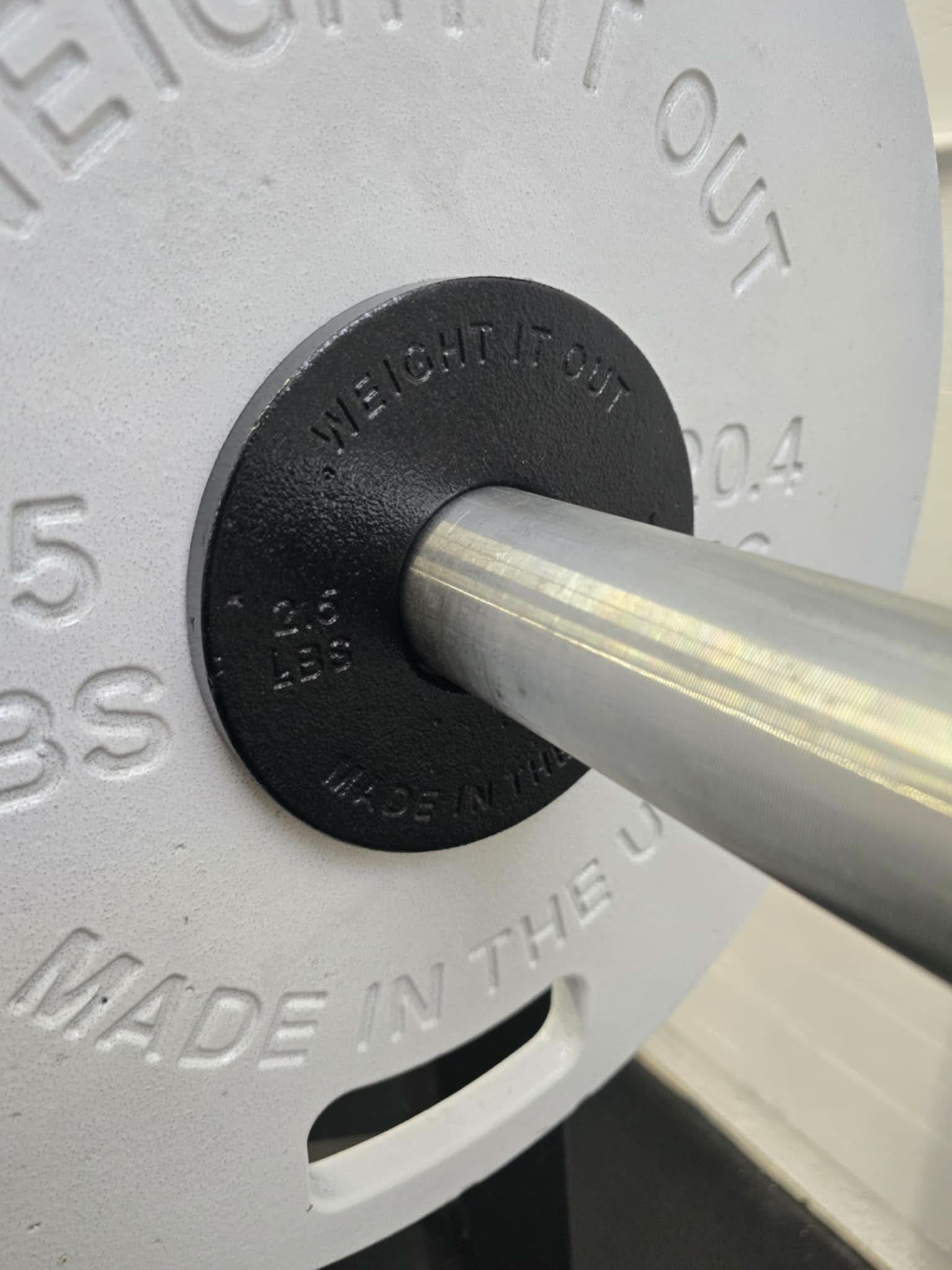 Cast Iron Machined Weight Plate Sets - perspective view of plates loaded on barbell sleeve