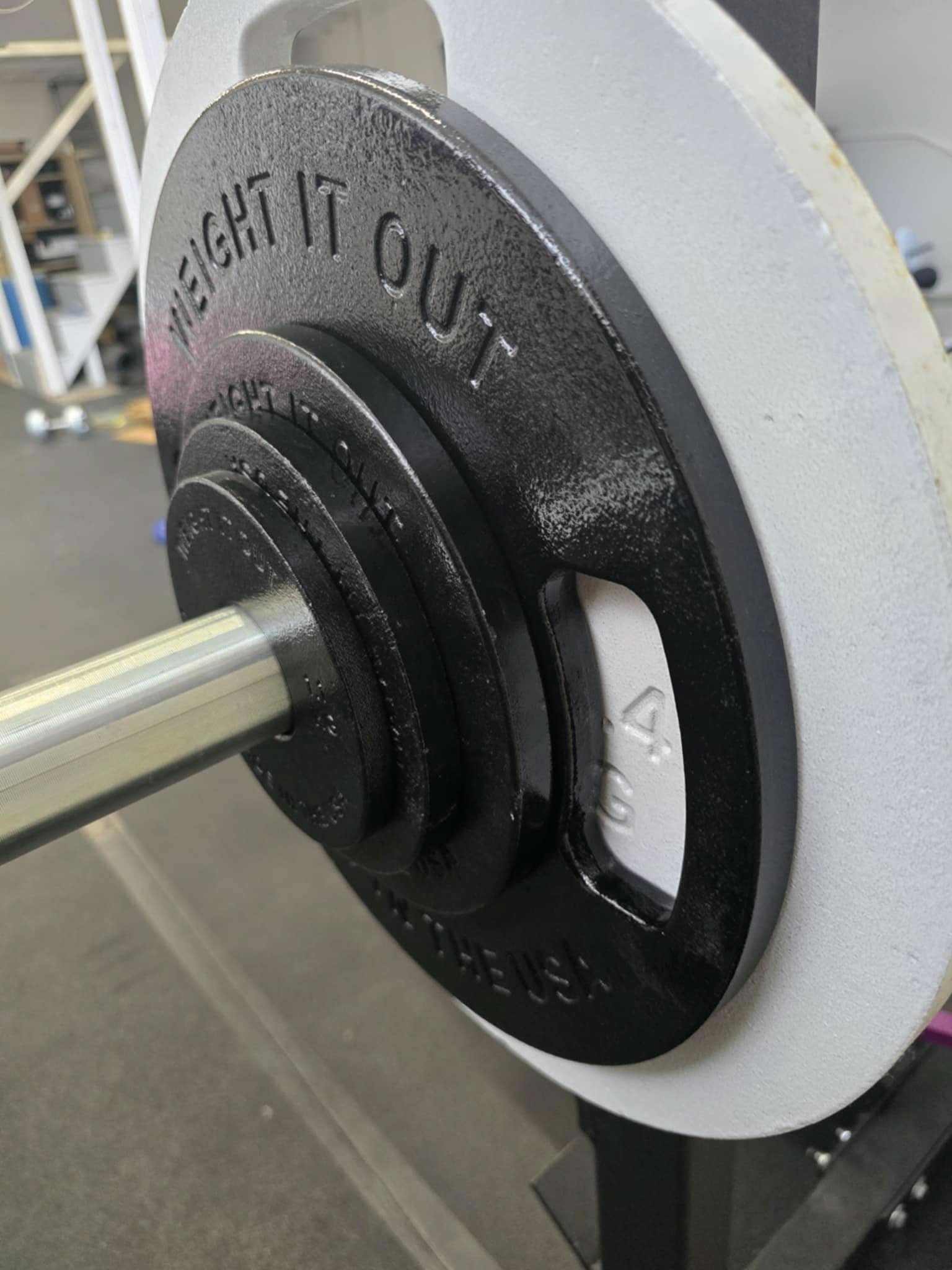 Cast Iron Machined Weight Plate Sets - close up view of plates loaded on barbell sleeve