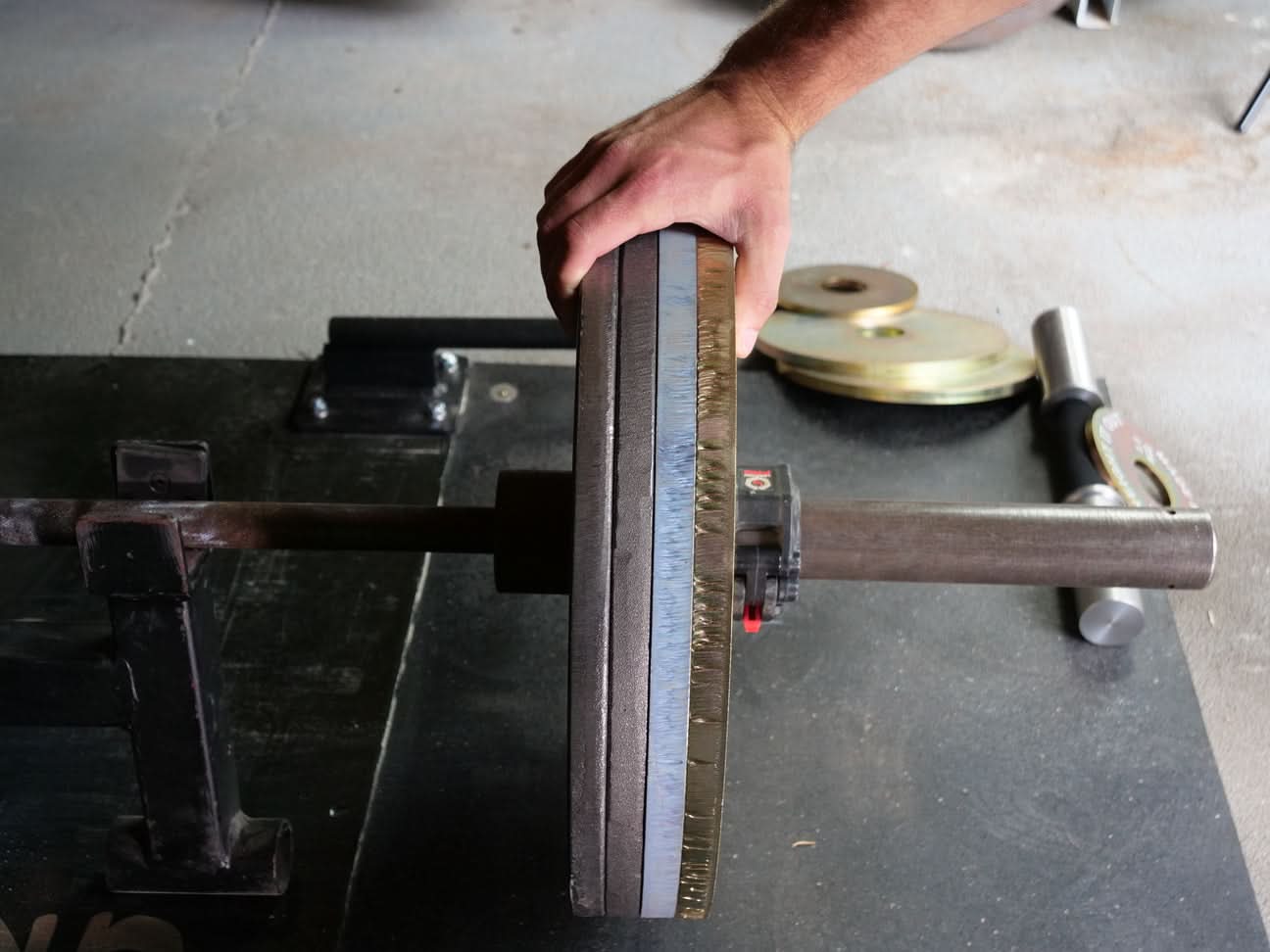 Cast Iron Machined Weight Plate Pairs - close up view of plates stacked on the barbell
