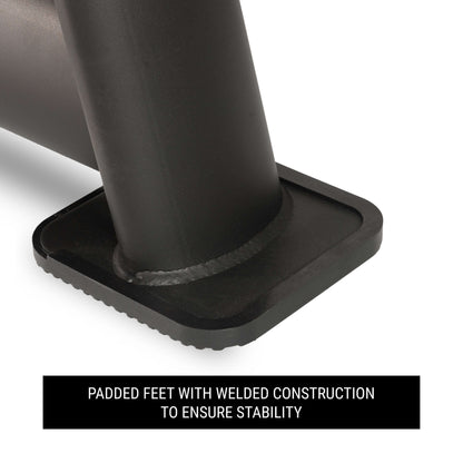 Close-up of padded feet on a dumbbell rack, featuring welded construction for enhanced stability.