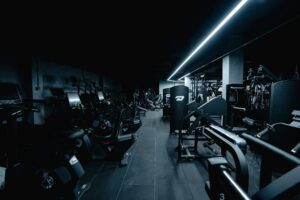 Commercial gym floor lined with strength and cardio equipment
