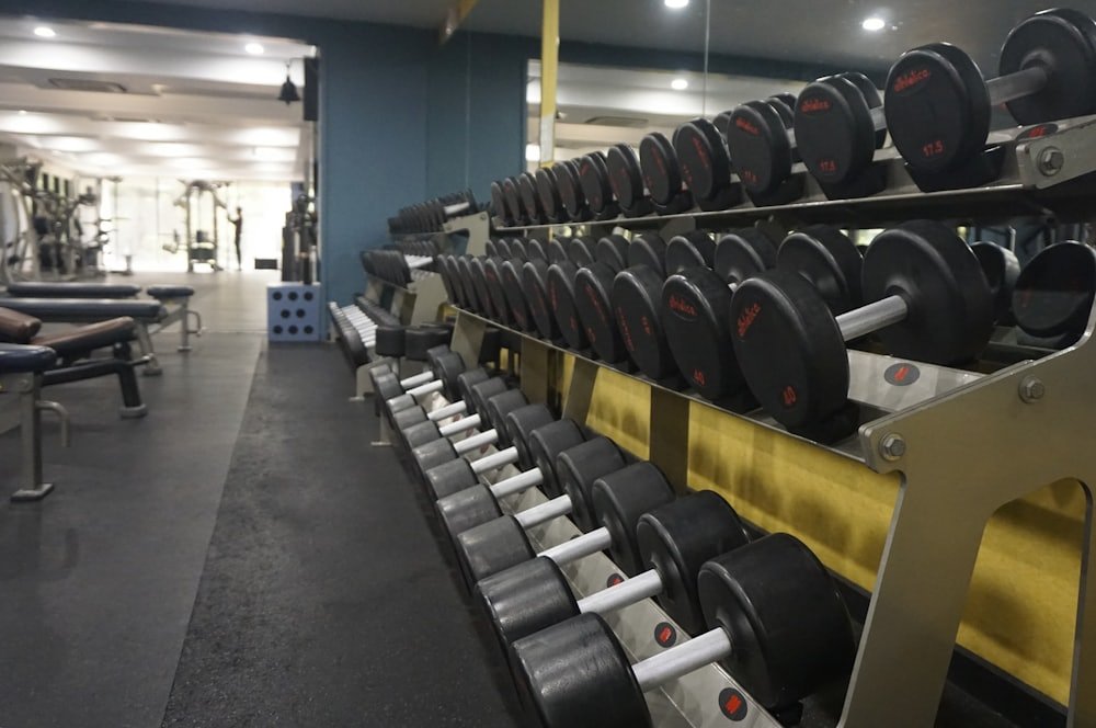 Dumbbells organised on a commercial dumbbell rack